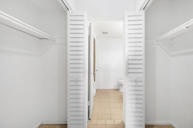 spacious closet featuring light tile patterned floors