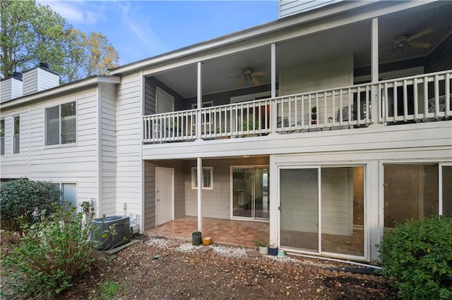 back of house with central AC, a balcony, and ceiling fan