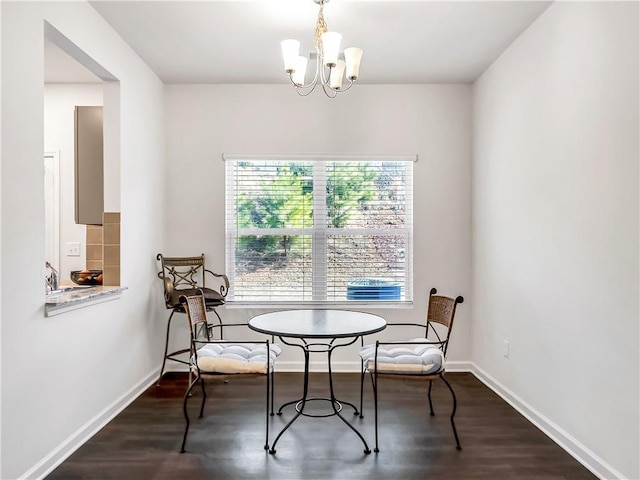 dining area featuring a notable chandelier and dark hardwood / wood-style flooring