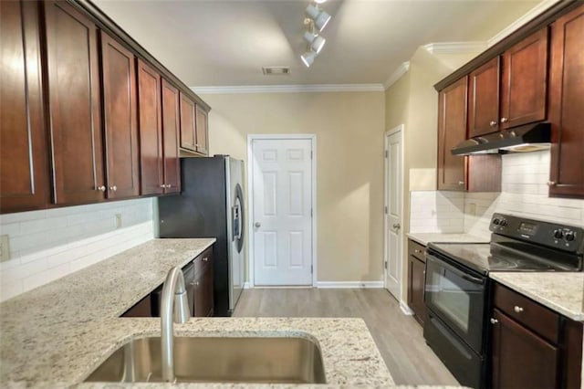 kitchen featuring electric range, ornamental molding, a sink, light stone countertops, and under cabinet range hood