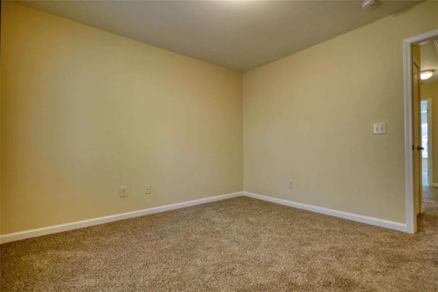 carpeted empty room with baseboards