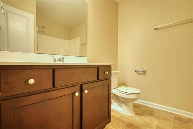 full bathroom with tile patterned floors, vanity, toilet, and baseboards