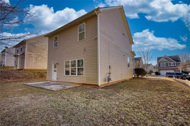 back of property with a patio area and a lawn