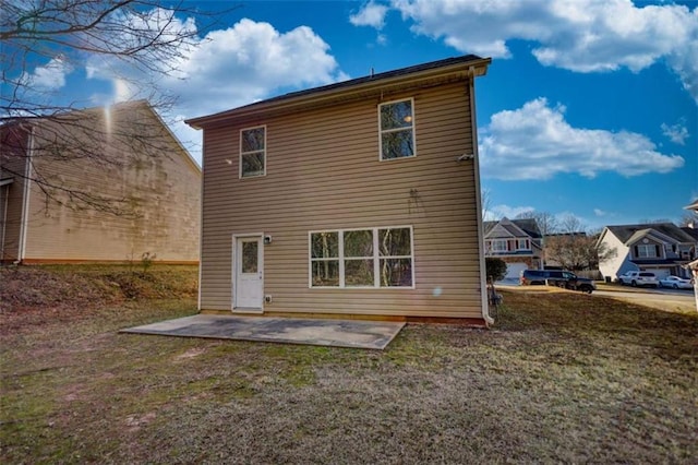 back of property featuring a yard and a patio