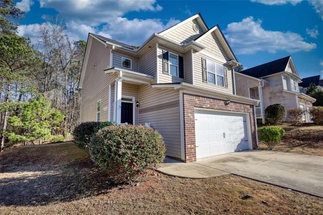 view of property exterior featuring a garage, driveway, and brick siding