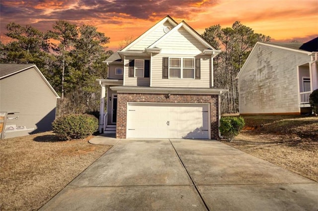 view of front of house with a garage, concrete driveway, and brick siding