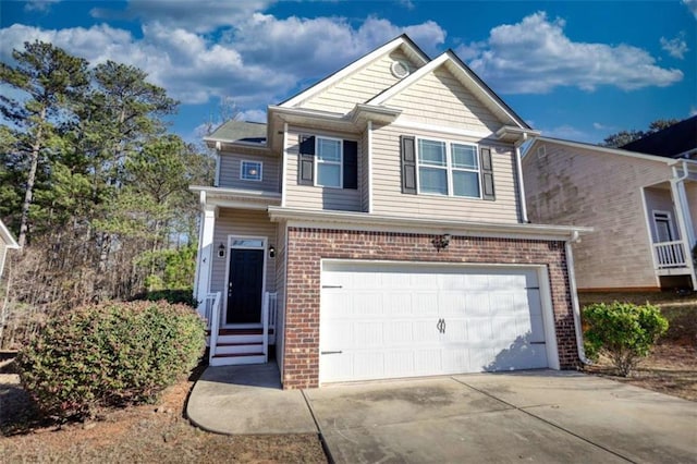 view of front facade featuring a garage, driveway, and brick siding