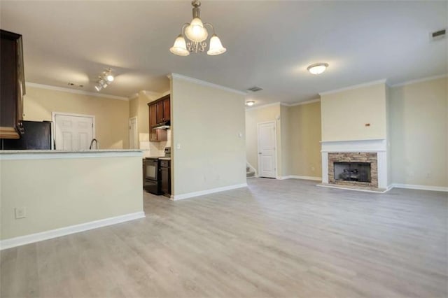 unfurnished living room featuring a stone fireplace, light wood finished floors, visible vents, and baseboards