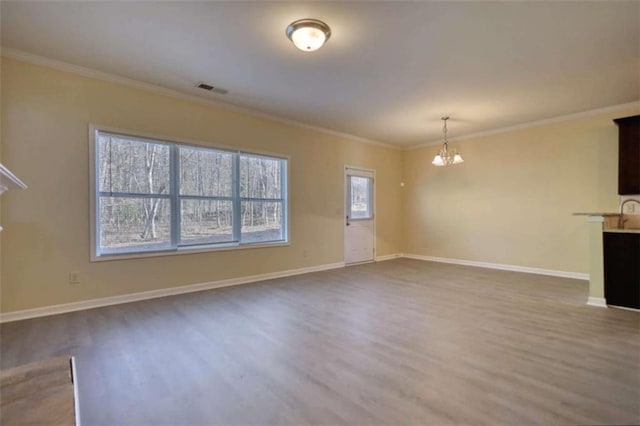 unfurnished living room featuring dark wood-style floors, baseboards, visible vents, and crown molding