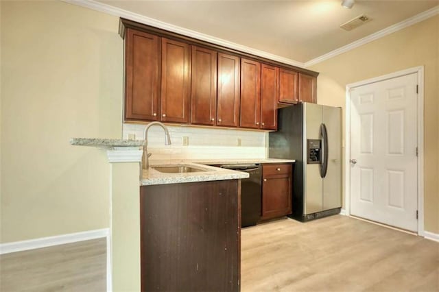 kitchen featuring a sink, ornamental molding, stainless steel refrigerator with ice dispenser, dishwasher, and tasteful backsplash