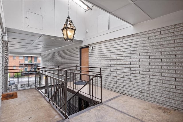 interior space featuring concrete flooring and brick wall