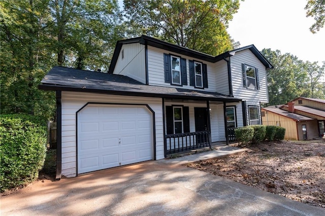 view of front property featuring a garage and a porch