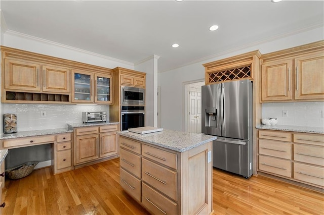 kitchen with light stone counters, open shelves, appliances with stainless steel finishes, ornamental molding, and glass insert cabinets