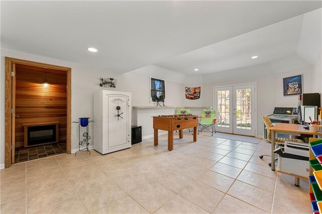 playroom with light tile patterned floors, recessed lighting, a fireplace, and french doors