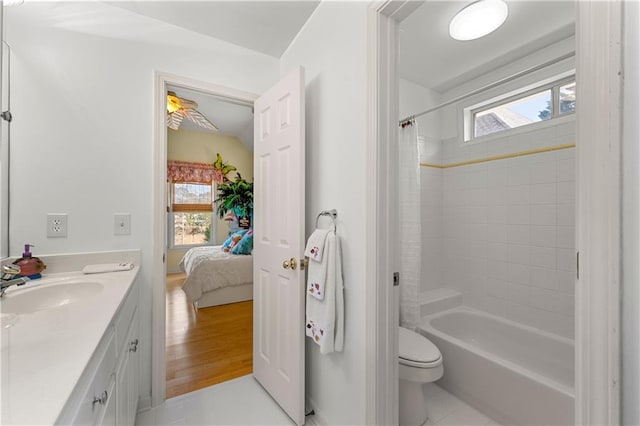 bathroom with shower / bath combo, a healthy amount of sunlight, toilet, and ensuite bath