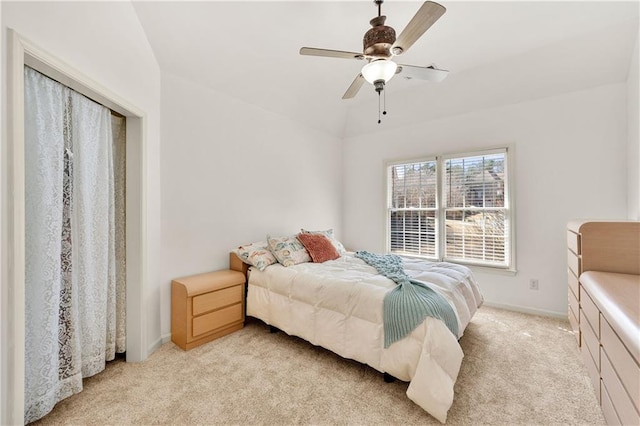 bedroom featuring light carpet, ceiling fan, lofted ceiling, and baseboards