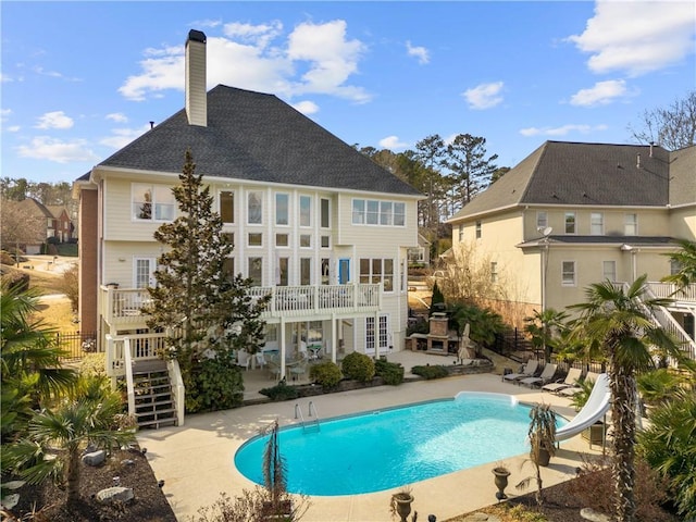 view of swimming pool with a patio, a water slide, fence, french doors, and a fenced in pool