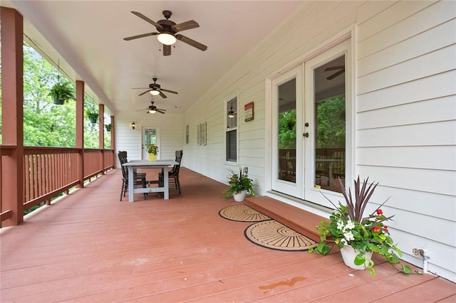 deck featuring french doors, outdoor dining space, and ceiling fan
