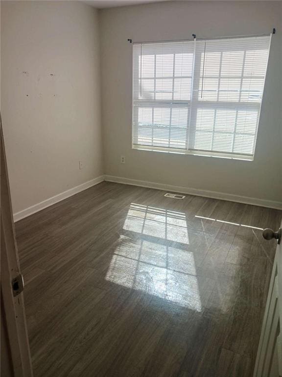 empty room with dark hardwood / wood-style floors