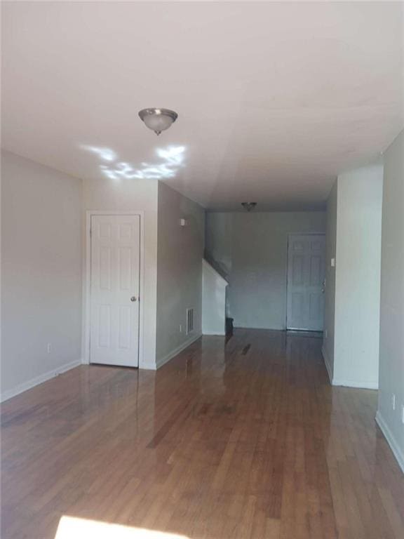 spare room with dark wood-type flooring