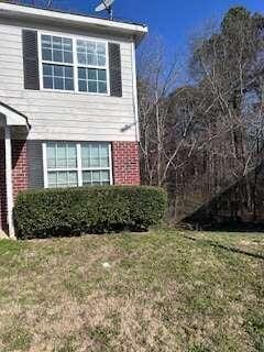 view of side of property with a yard