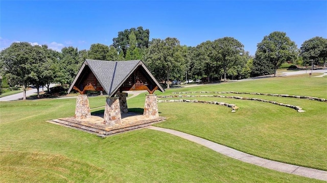 surrounding community with a gazebo and a yard