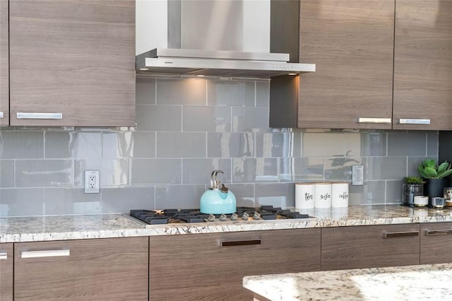 45 Ivan Allen Jr Blvd NW Unit 2505, Atlanta, GA 30308 - kitchen with wall chimney exhaust hood, stainless steel gas stovetop, modern cabinets, and tasteful backsplash