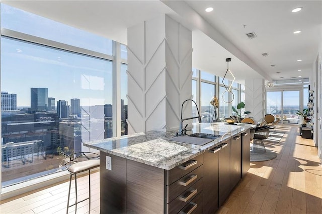45 Ivan Allen Jr Blvd NW Unit 2505, Atlanta, GA 30308 - kitchen with a sink, open floor plan, an island with sink, hardwood / wood-style flooring, and modern cabinets
