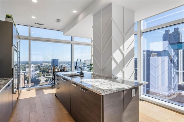 45 Ivan Allen Jr Blvd NW Unit 2505, Atlanta, GA 30308 - kitchen with a sink, a view of city, expansive windows, modern cabinets, and hardwood / wood-style floors