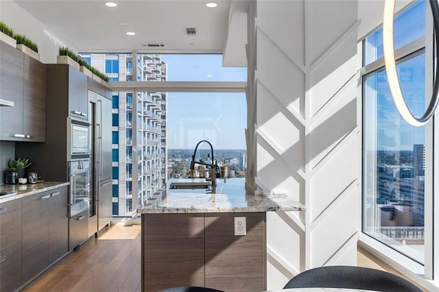 45 Ivan Allen Jr Blvd NW Unit 2505, Atlanta, GA 30308 - kitchen with floor to ceiling windows, a sink, modern cabinets, dark wood finished floors, and a city view