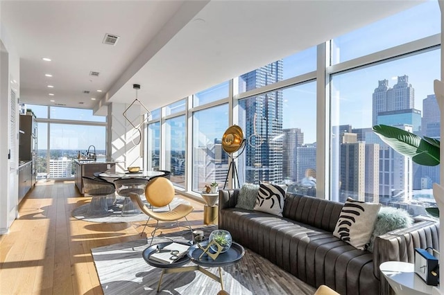 45 Ivan Allen Jr Blvd NW Unit 2505, Atlanta, GA 30308 - living area featuring a wall of windows, wood-type flooring, and a view of skyline