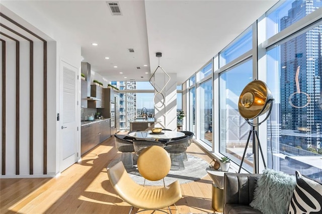 45 Ivan Allen Jr Blvd NW Unit 2505, Atlanta, GA 30308 - dining space featuring light wood-type flooring, floor to ceiling windows, a city view, and recessed lighting
