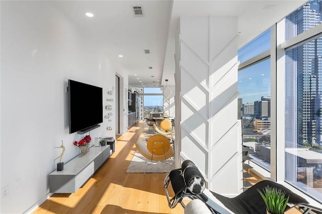 45 Ivan Allen Jr Blvd NW Unit 2505, Atlanta, GA 30308 - living area featuring wood finished floors, a wall of windows, and recessed lighting