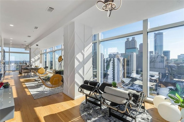 45 Ivan Allen Jr Blvd NW Unit 2505, Atlanta, GA 30308 - living area with floor to ceiling windows, hardwood / wood-style floors, plenty of natural light, and a skyline view