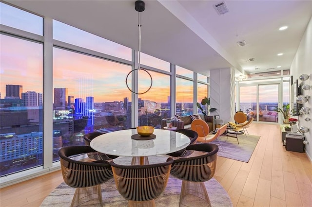 45 Ivan Allen Jr Blvd NW Unit 2505, Atlanta, GA 30308 - dining area with wood finished floors, a city view, and expansive windows