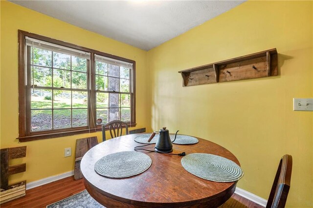 dining area featuring baseboards and wood finished floors