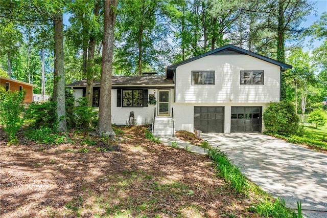 tri-level home featuring driveway and a garage