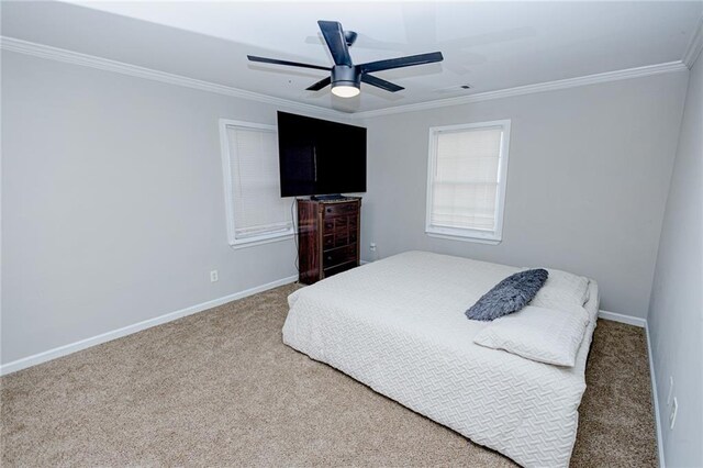 bedroom with a ceiling fan, baseboards, carpet floors, visible vents, and crown molding