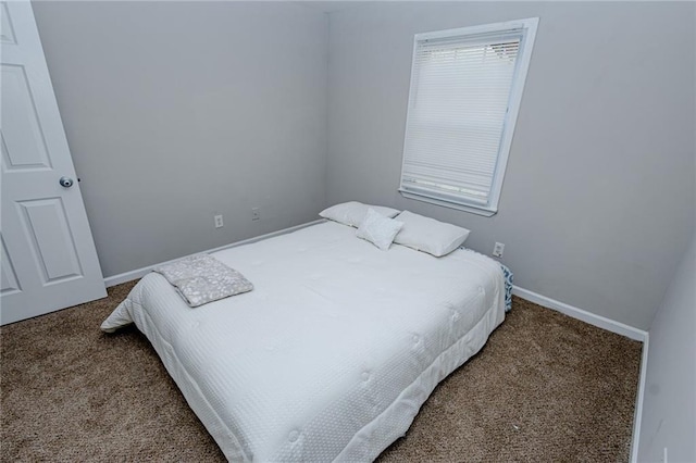 bedroom featuring baseboards and carpet flooring