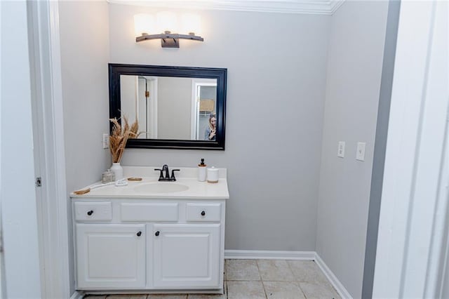 bathroom with baseboards, vanity, and tile patterned flooring