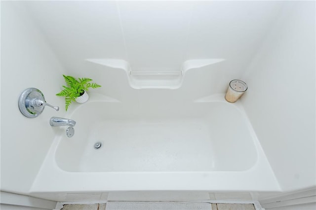 room details featuring a bathing tub and walk in shower