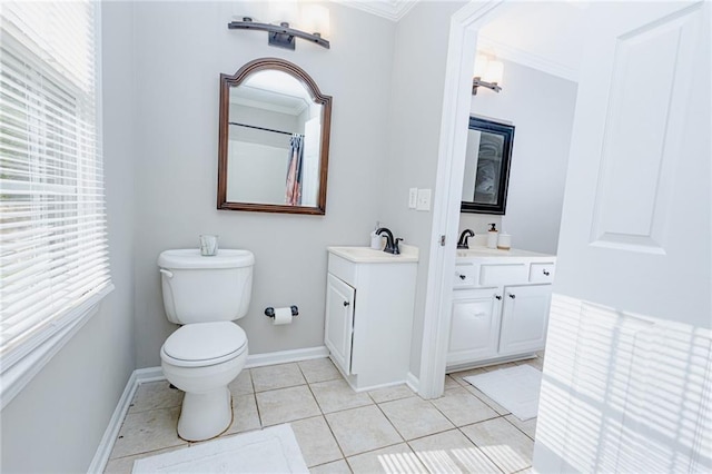 bathroom featuring tile patterned floors, toilet, ornamental molding, baseboards, and vanity