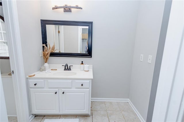 bathroom with tile patterned floors, vanity, and baseboards