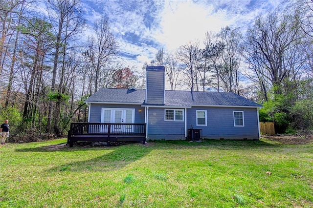 back of house with a deck, cooling unit, a chimney, and a yard