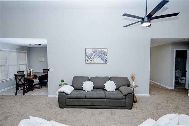 living area with carpet flooring, a ceiling fan, and baseboards