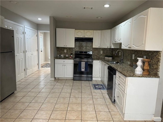 kitchen with visible vents, range with electric cooktop, under cabinet range hood, freestanding refrigerator, and a sink