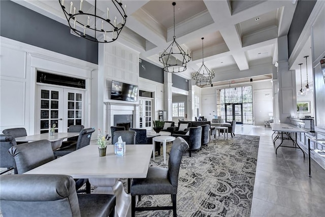 dining space featuring a high ceiling, coffered ceiling, french doors, crown molding, and beam ceiling