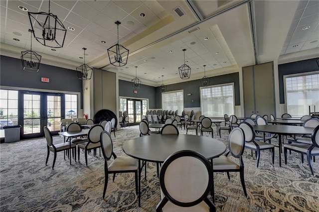 dining area featuring french doors, carpet, and a high ceiling