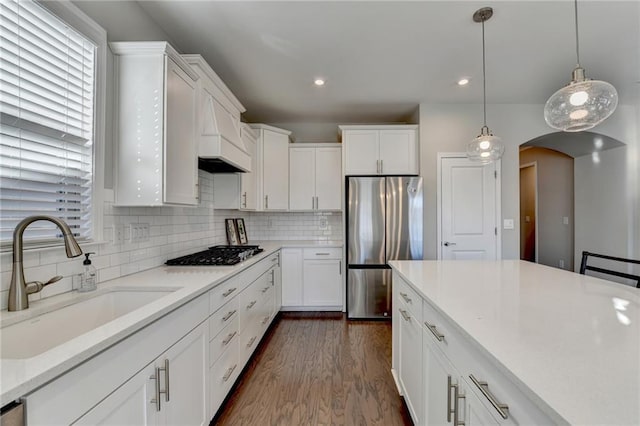 kitchen with dark hardwood / wood-style flooring, sink, white cabinetry, and stainless steel appliances