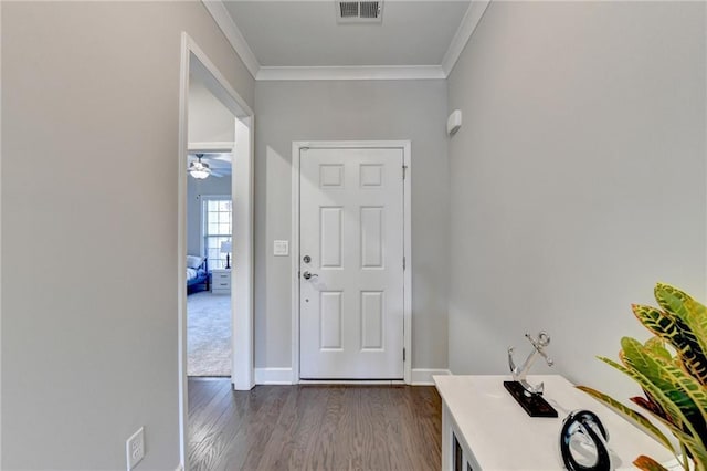 entryway with ceiling fan, crown molding, and dark wood-type flooring